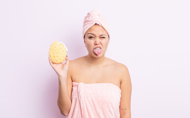 Wall Mural - hispanic pretty woman feeling disgusted and irritated and tongue out. bathrobe and sponge concept