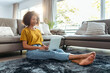 © nenetus - Relaxed mature woman working with her laptop while sitting on the floor at home.