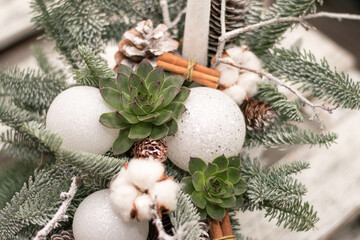 christmas table decoration with candles, globes and cones