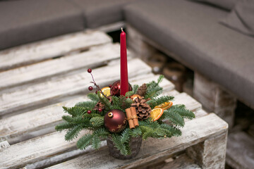 Wall Mural - Christmas table decoration with candles, globes and cones