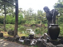 Buddha Statue Beside A Pond