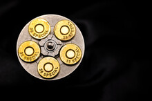 .38 Special Gun Bullets With Stainless Revolver Cylinder On Black Background , Top View