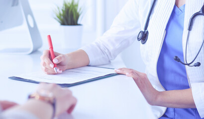 A serious female doctor examining a patient's lymph nodes