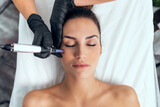 Fototapeta  - Cosmetologist making mesotherapy injection with dermapen on face for rejuvenation on the spa center.
