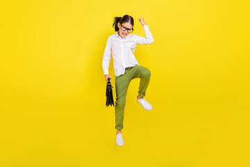 Poster - Full length body size view of attractive cheerful lucky girl jumping rejoicing isolated over bright yellow color background