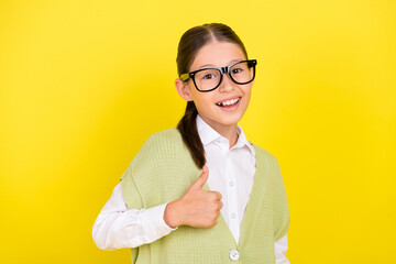 Poster - Portrait of attractive glad lucky cheerful girl showing thumbup ad cool isolated over bright yellow color background