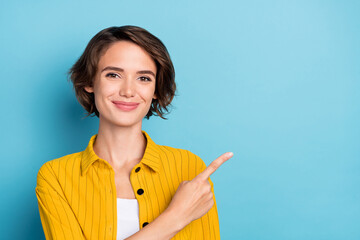 Photo of reliable lady indicate forefinger side empty space wear yellow shirt isolated blue color background