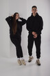 Couple posing in studio wearing black hoodie