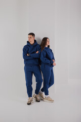 Wall Mural - Couple posing in studio wearing blue hoodie