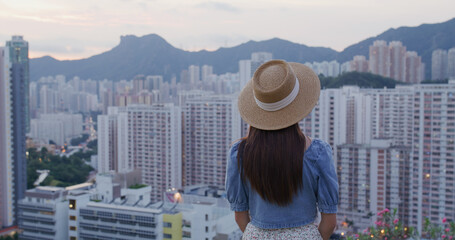 Canvas Print - Woman look at the city of Hong Kong at sunset