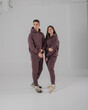 © antgor - Couple posing in studio wearing brown hoodie
