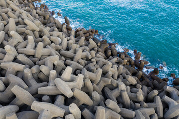 Wall Mural - Top down view of the wave breaker over the sea