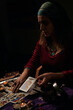 © Cristian Blázquez - Pythoness reads tarot cards in a dark environment
