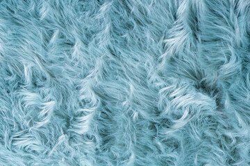 Trendy artificial fur texture. Fur pattern top view. Blue fur background. Texture of blue shaggy fur. Wool texture. Flaffy sheepskin close up