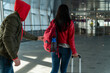 © NFstock - Full length of the unrecognizable thief stealing something from the backpack of brunette woman in the lobby of airport. Criminal concept