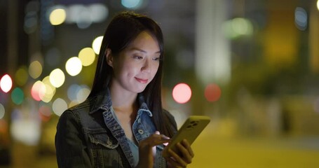 Wall Mural - Woman use smart phone in city at night