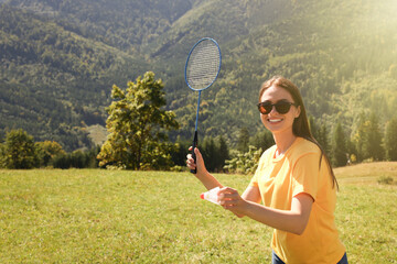 Canvas Print - Woman playing badminton in mountains on sunny day. Space for text