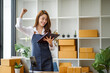 © David - Portrait of Asian young woman SME working with a box at home the workplace.start-up small business owner, small business entrepreneur SME or freelance business online and delivery concept.