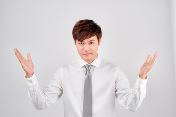 Excited surprised handsome young Asian man in casual white shirt doing open hand gesture