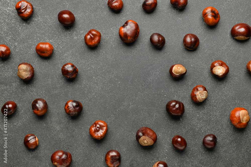 Frame made of chestnuts on dark background, closeup