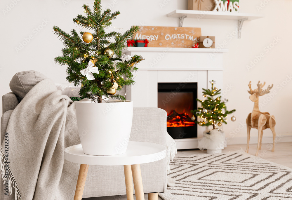 Beautiful small Christmas tree on table in light living room