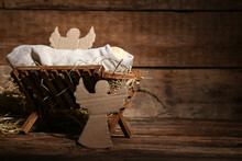 Manger With Dummy Of Baby And Paper Angels On Wooden Background. Concept Of Christmas Story