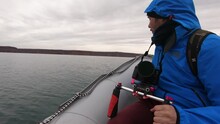 Cameraman Traveling In A Motor Boat Across The Lake