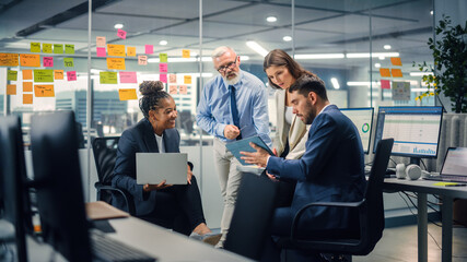 in modern office: diverse team of managers use laptop and tablet computers at a company meeting disc