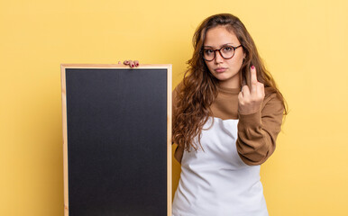 Wall Mural - hispanic pretty woman feeling angry, annoyed, rebellious and aggressive. blackboard copy space concept