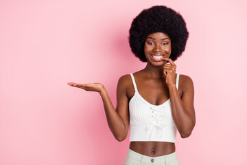 Sticker - Photo portrait curly girl in white top biting nail keeping blank space on hand isolated pink color background copyspace