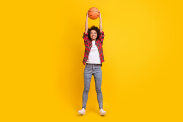 Wall Mural - Full length body size view of attractive cheerful girl throwing catching ball having fun isolated over bright yellow color background