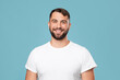 © Prostock-studio - Happy handsome mature caucasian guy with beard in white t-shirt looking at camera