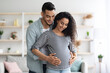© Prostock-studio - Loving middle eastern husband hugging his beautiful pregnant wife
