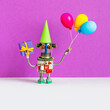 A festive greeting card for any event or birthday party. A happy robot in a paper green hat holds balloons. Congratulations poster template. violet gray background.