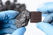 © nevodka.com - Coal next to solar panel in scientist hands in laboratory. Green energy transition research.