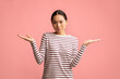 © Prostock-studio - Difficult Choice. Doubtful Young Asian Woman Shrugging Shoulders And Spreading Arms