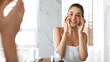 © Prostock-studio - Attractive Lady Applying Patches Moisturizing Skin Under Eyes In Bathroom