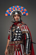 Proud roman centurion warrior with plumed helmet isolated on gray