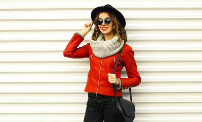 Wall Mural - Portrait of beautiful young woman posing wearing a red jacket, black round hat on white background