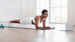 © Prostock-studio - Young black woman planking in front of laptop