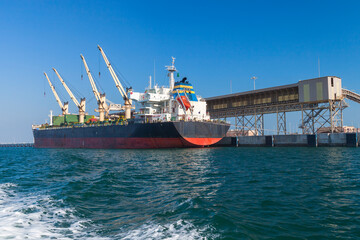 Wall Mural - Bulk carrier, cargo ship is loading in port