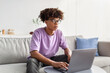 © Prostock-studio - Serious black teenager using laptop for online studies, making homework, getting ready for test at home