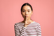 © Prostock-studio - Keep Silence. Mysterious Young Asian Woman Showing Shh Gesture At Camera