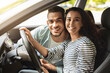 © Prostock-studio - Beautiful young woman driver posing inside new car with boyfriend