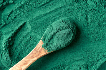 Wall Mural - Spirulina algae powder on a spoon, top view