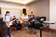 selective focus of a digital camera recording a video of a band group of young people performing