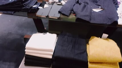 Wall Mural - Clothing retail and sustainable fashion concept. Assortment of luxury menswear, autumn and winter collection in mass market brand store. High quality 4k footage