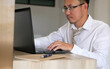 © WS Studio 1985 - Man using laptop computer at home. Businessman working in office. Freelance, student lifestyle, e-learning, studying, web site, technology and online shopping concept
