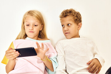 little boy and girl with phone playing entertainment