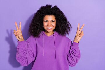 Sticker - Portrait of charming cheerful girl two arms make v-sign hello symbol isolated on violet color background